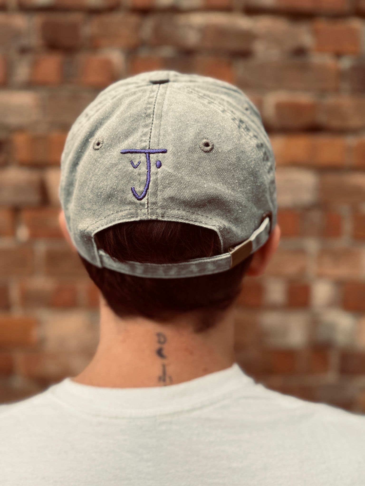 The Jolene house cap in gray with embroidered Jolene logo pictured on a model's head