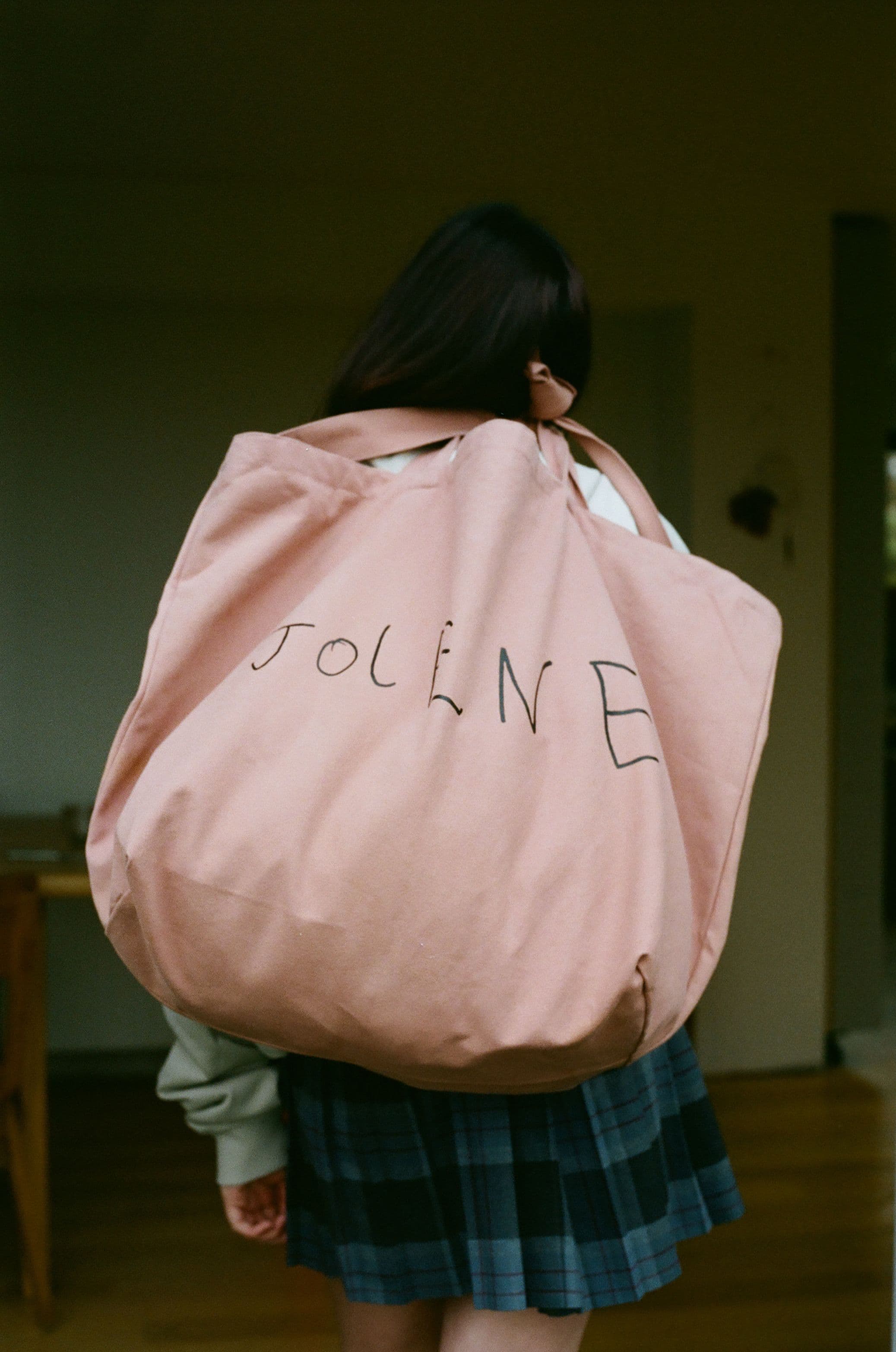 The Jolene big bag in pink pictured on the shoulder of a man outside Jolene Redchurch Street in London