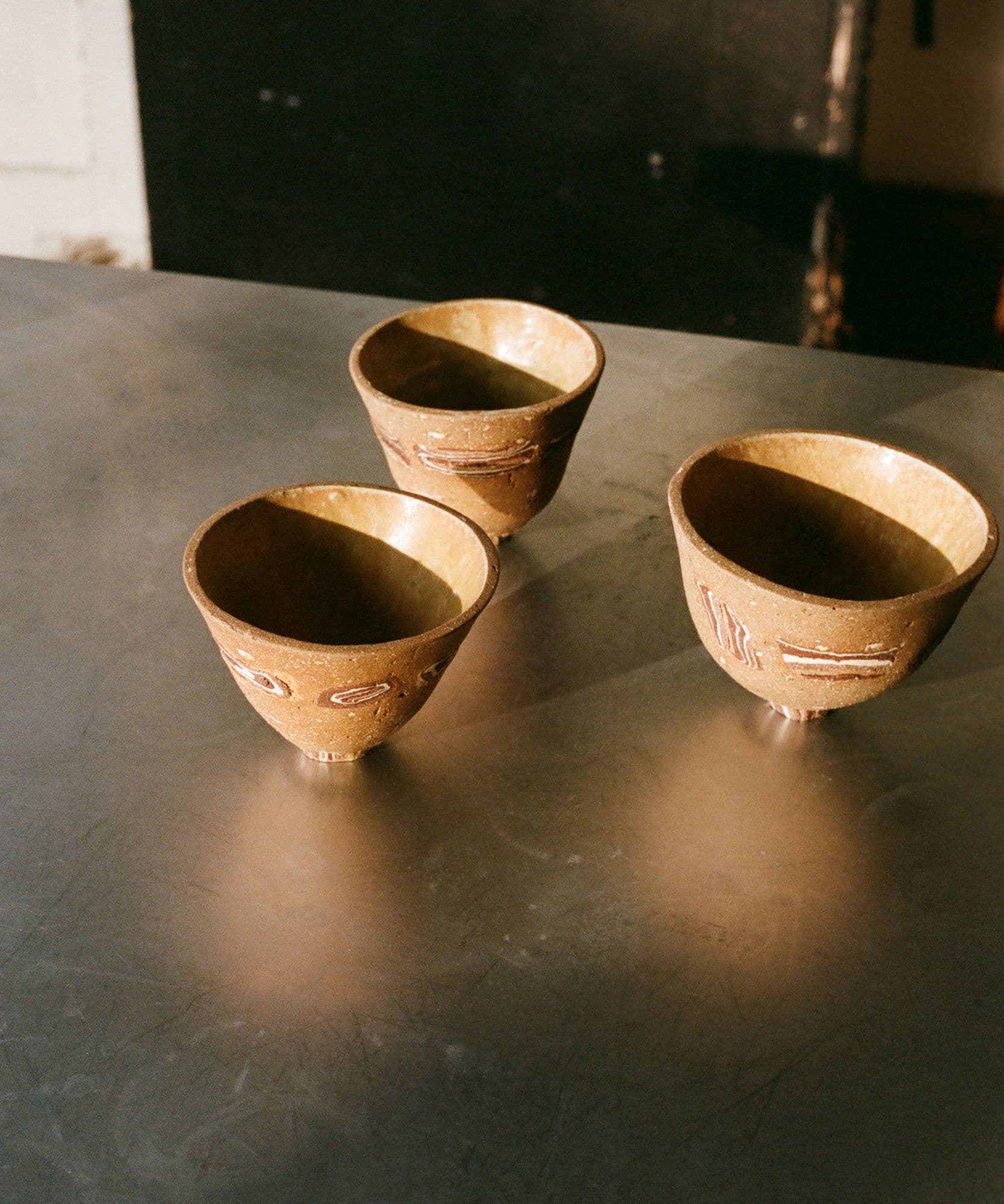 Three clay cups pictured in the dappled light at Primeur and for sale Jolene Bakery x Grainne Williams