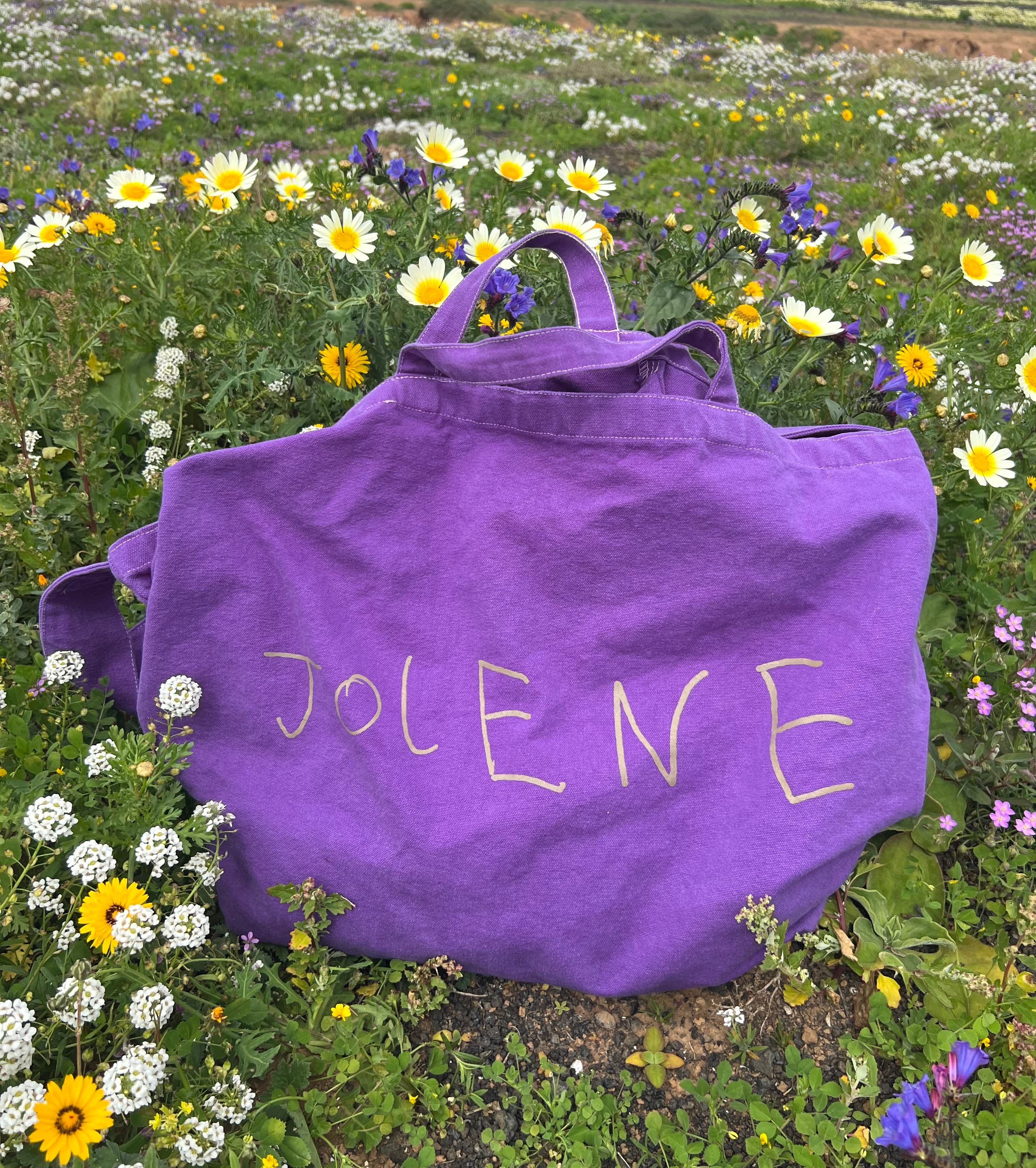 The Jolene big bag in pink pictured on the shoulder of a man outside Jolene Redchurch Street in London