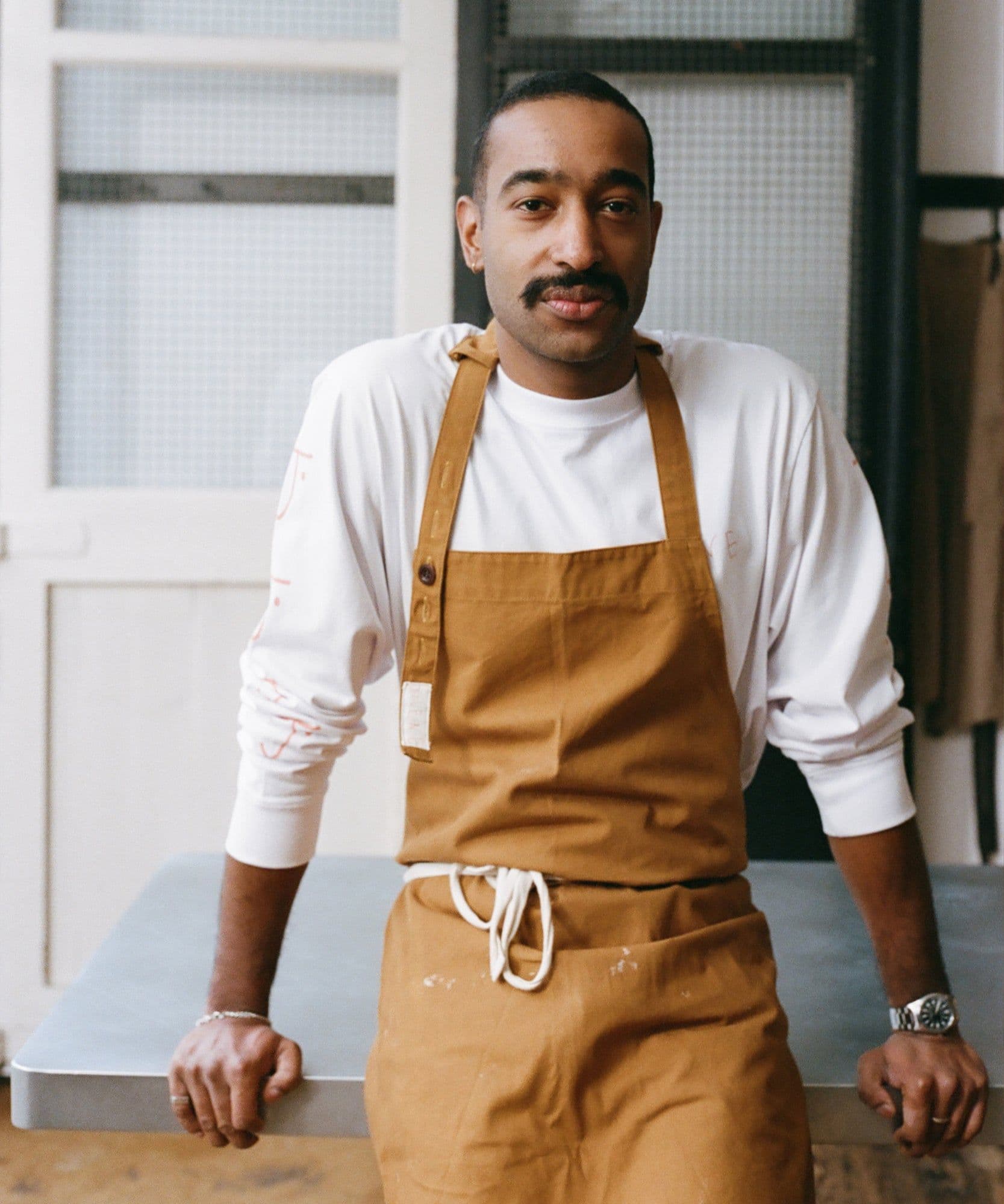 The Jolene Bakery house apron pictured here in the caramel colour worn by one of our chefs in the restaurant