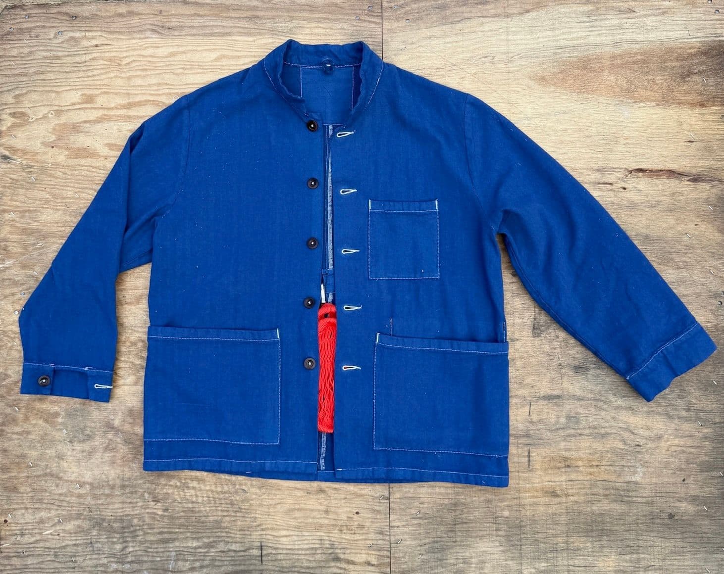 A product image of the Jolene Blue workwear Jacket lying flat on a wooden surface