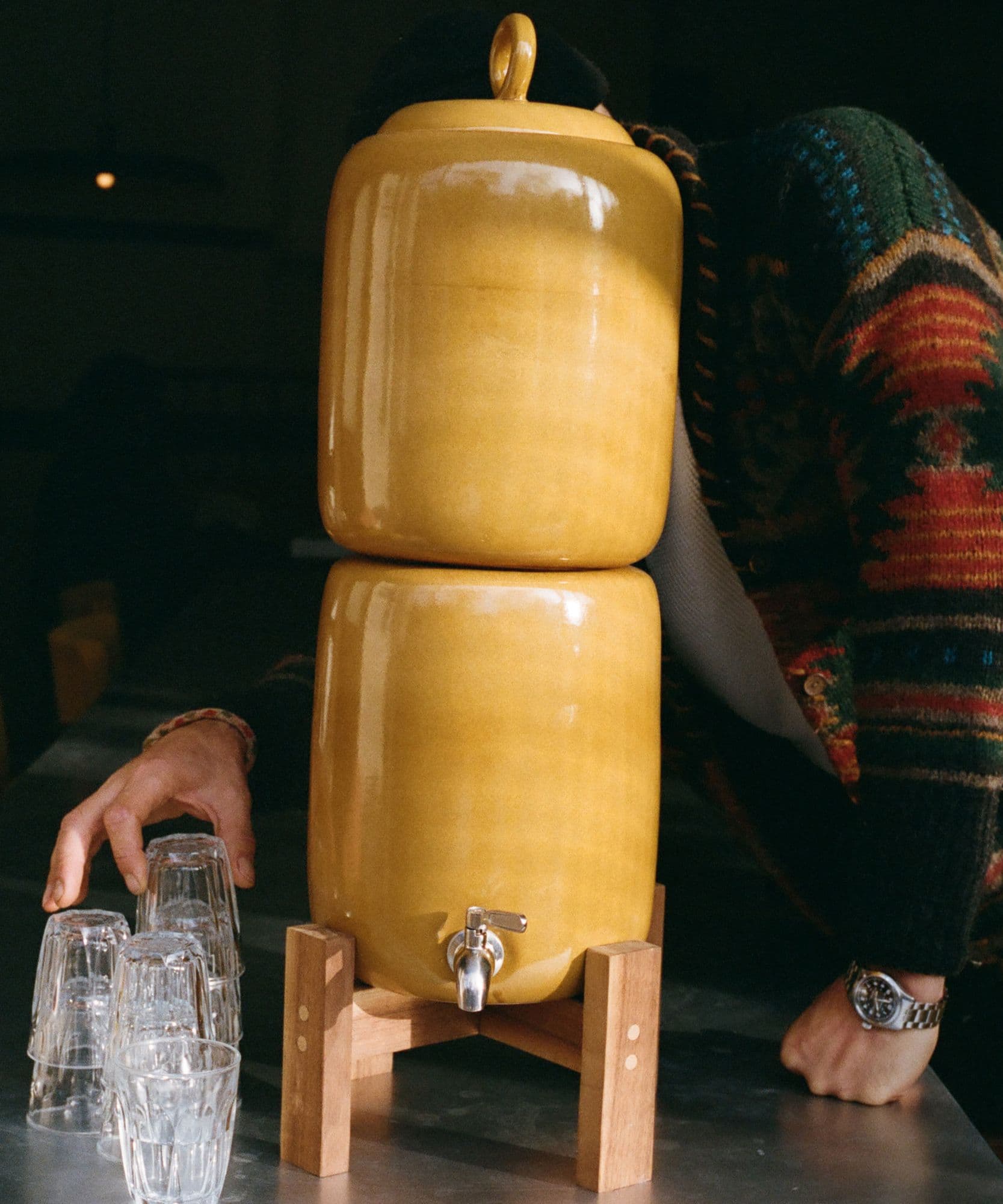 The Jolene bakery x Endless Rhythm water ceramic water filter in limited honey colour on a wooden stand