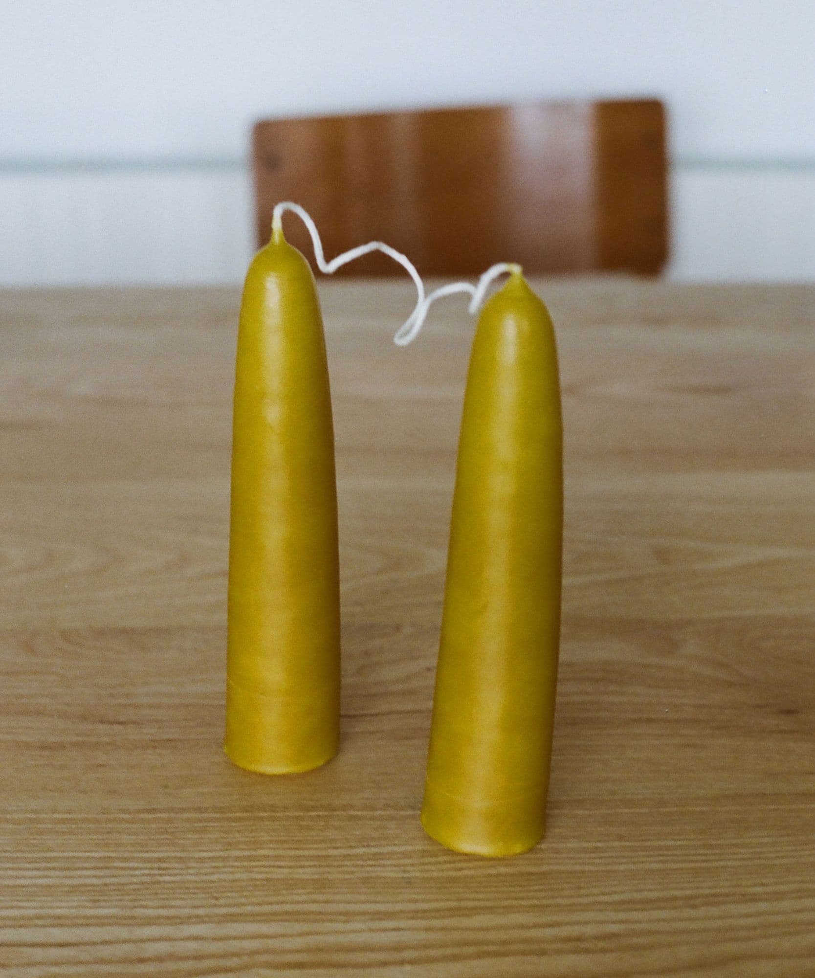 The Jolene bakery x Gina Portman candles on a wooden table