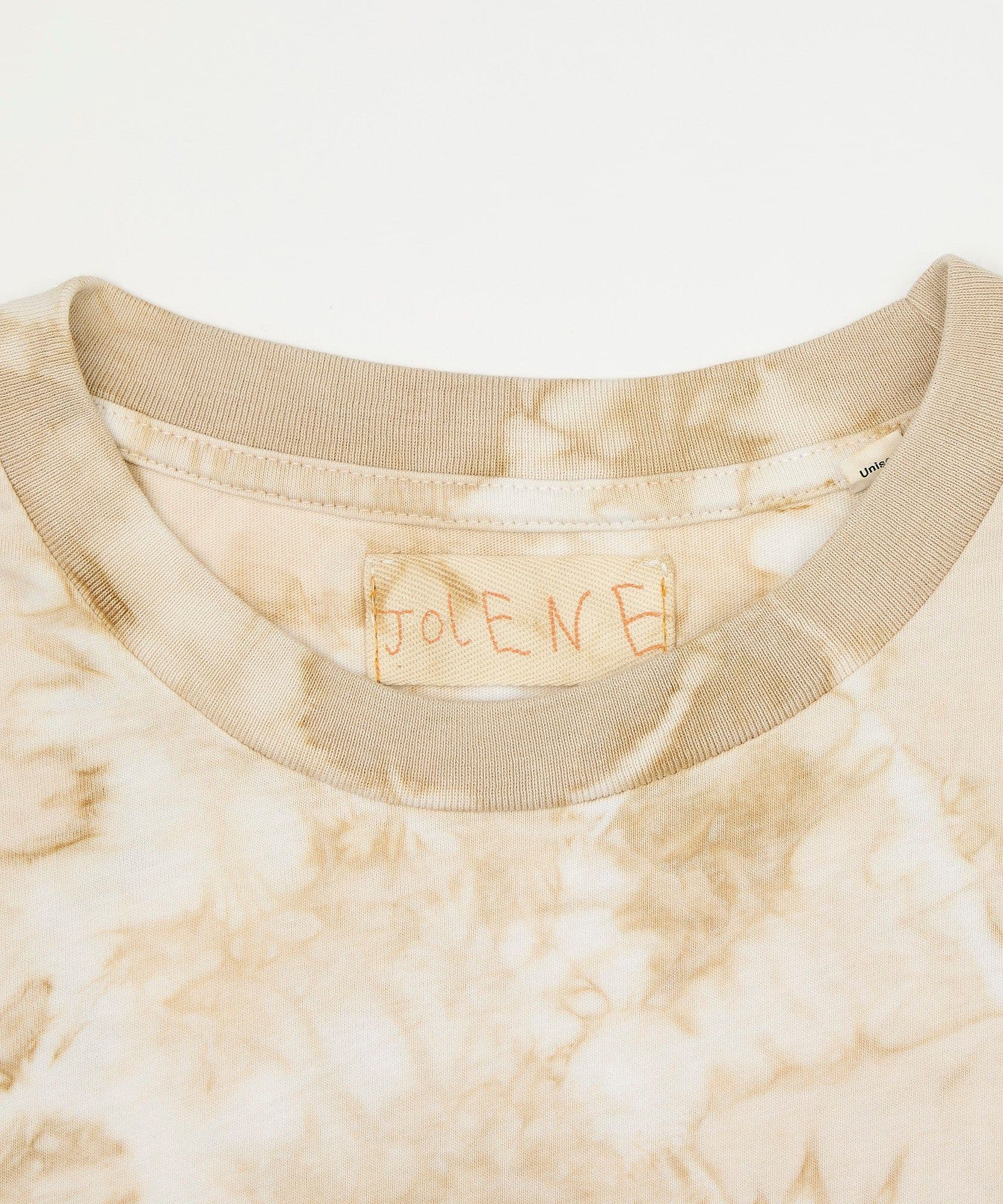 The neck detail showing the Jolene branding on the coffee dyed tee