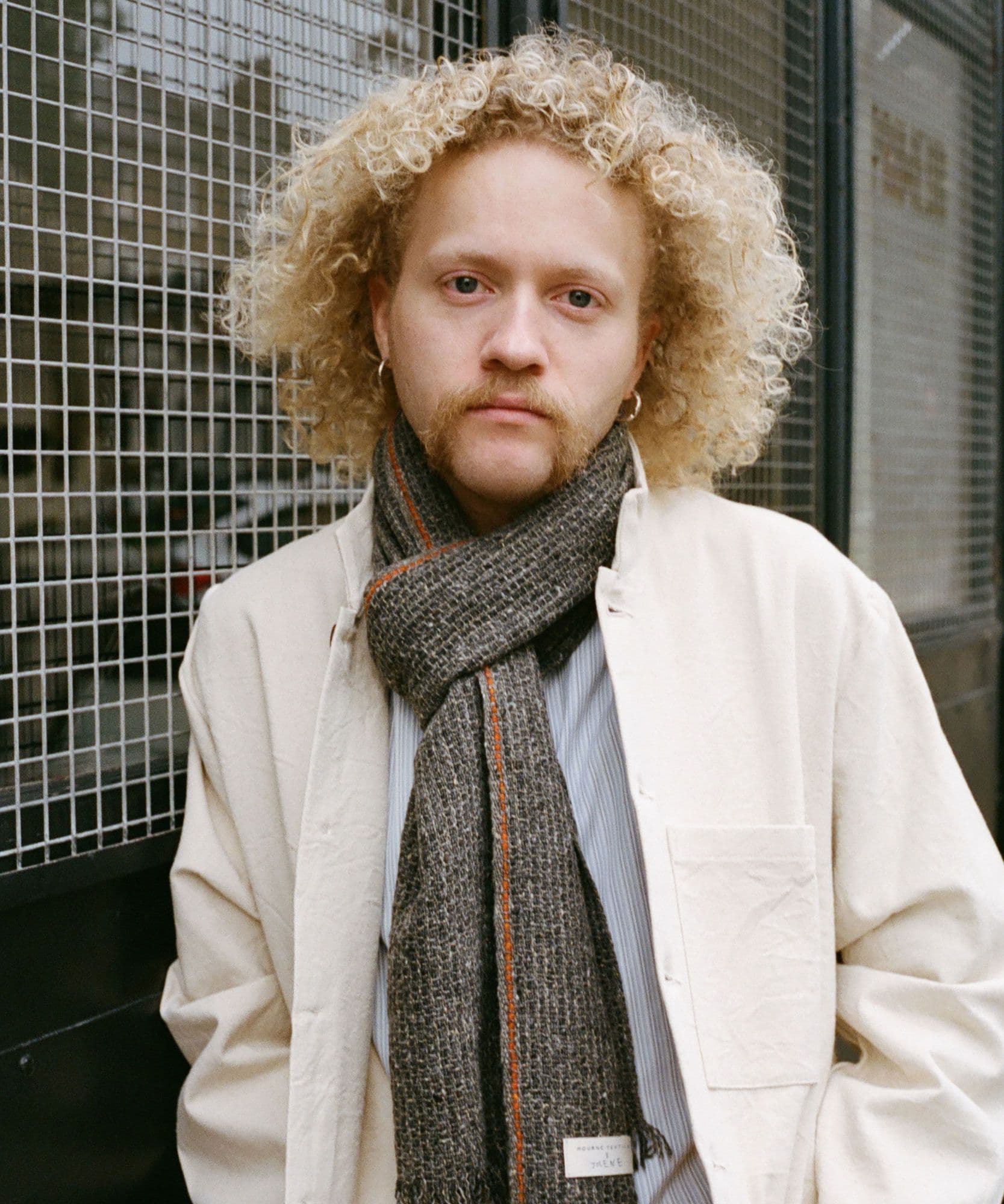 A male model wears the Jolene bakery Scarf x Mourne Textiles