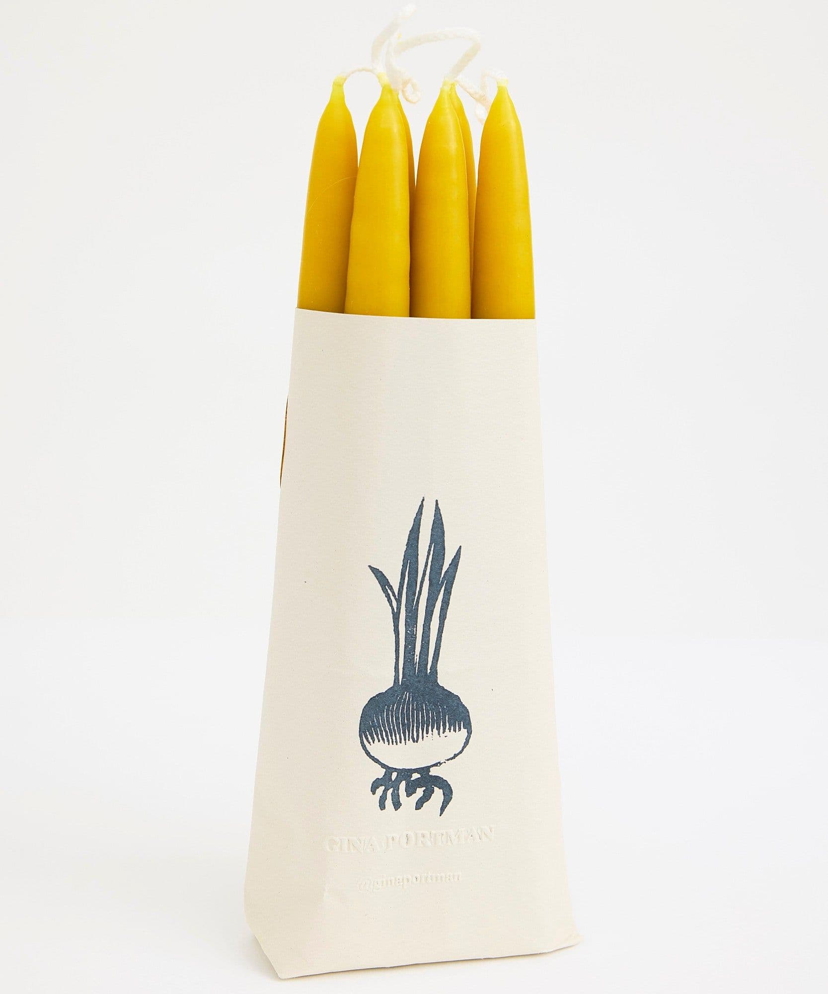 The Jolene bakery x Gina Portman candles wrapped in paper