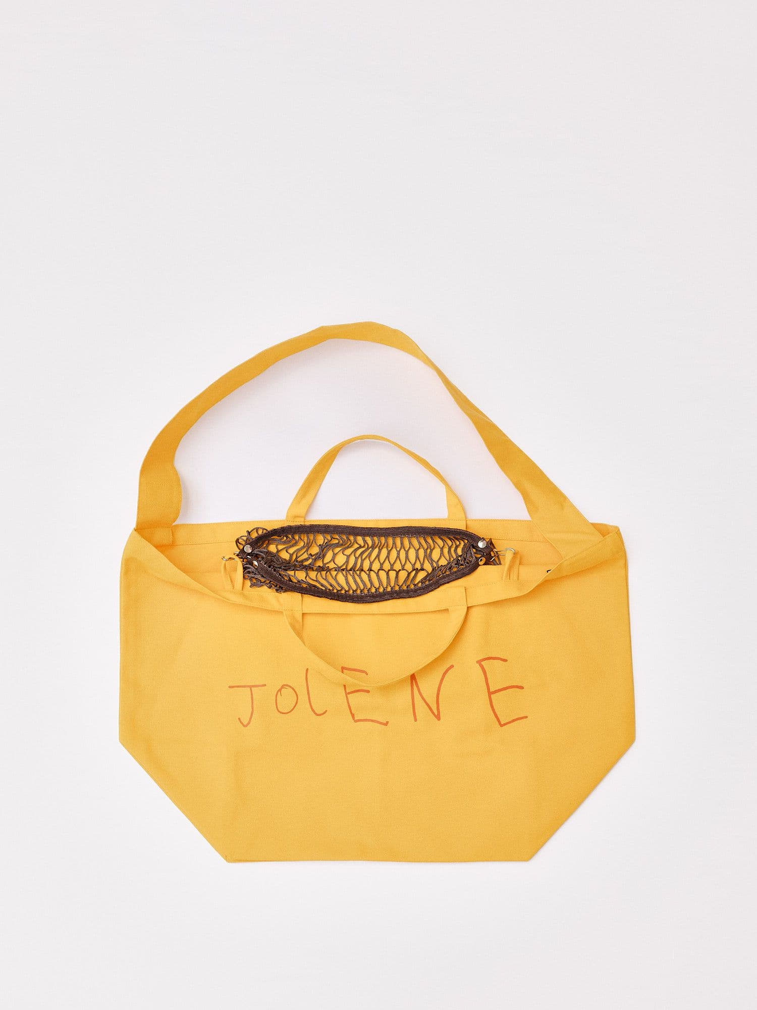 The Jolene bakery x filt of france net poacher pocket in brown, pictured clipped on the inside of the Jolene yellow big bag