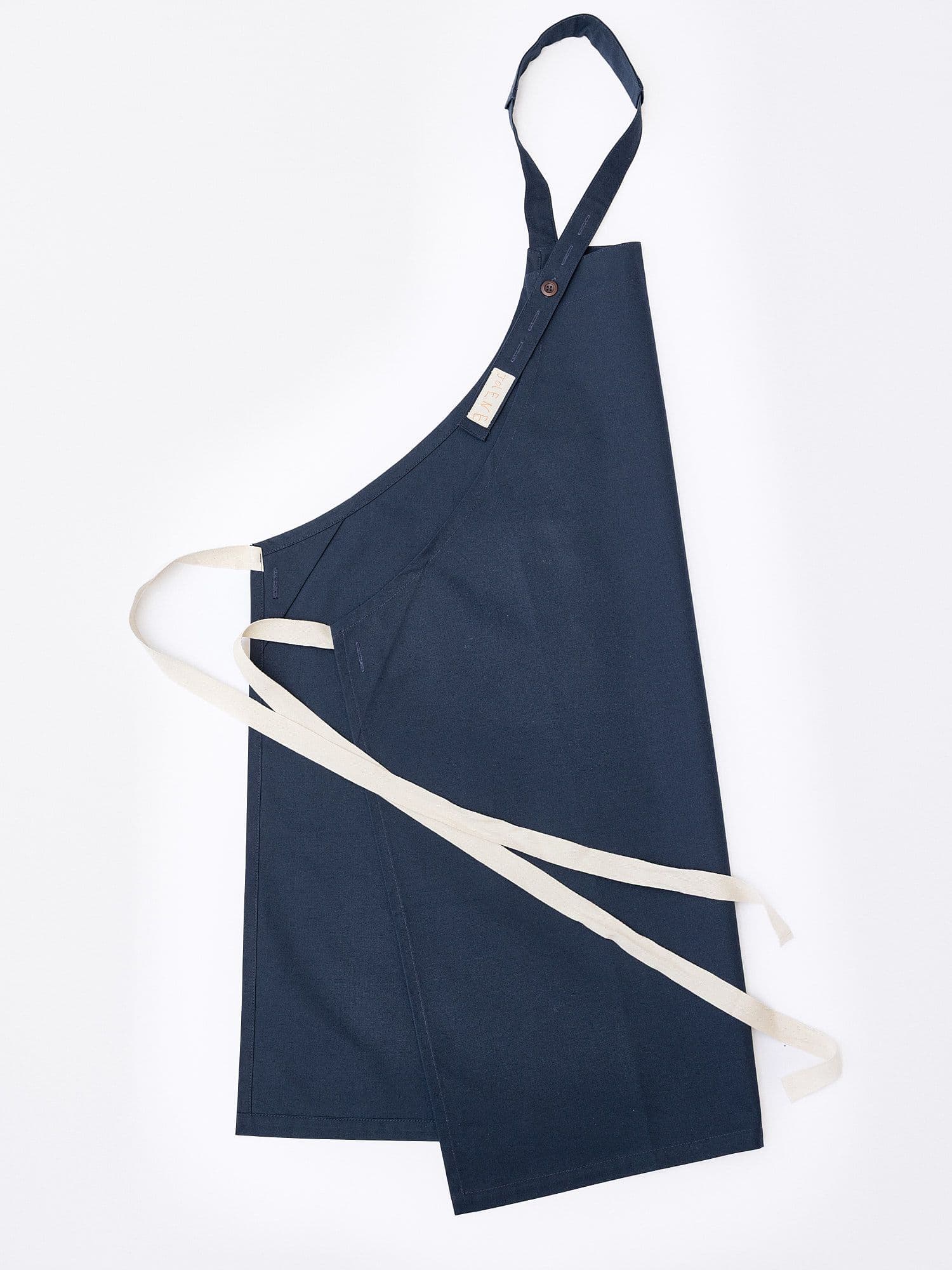 The Jolene Bakery house apron pictured here in the navy colour