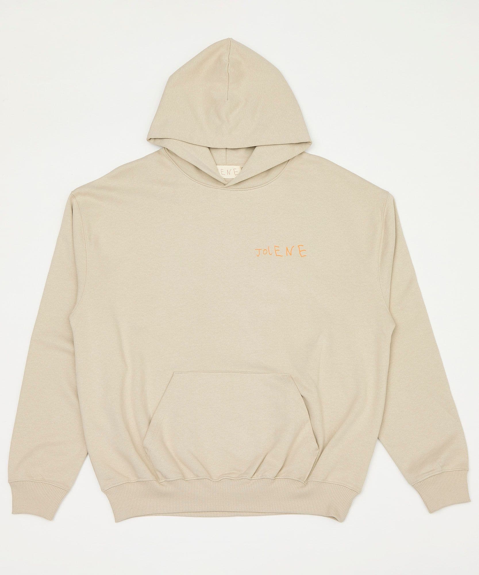 A male model standing outside with his back to the camera wearing the Jolene bakery J face hoodie in coffee