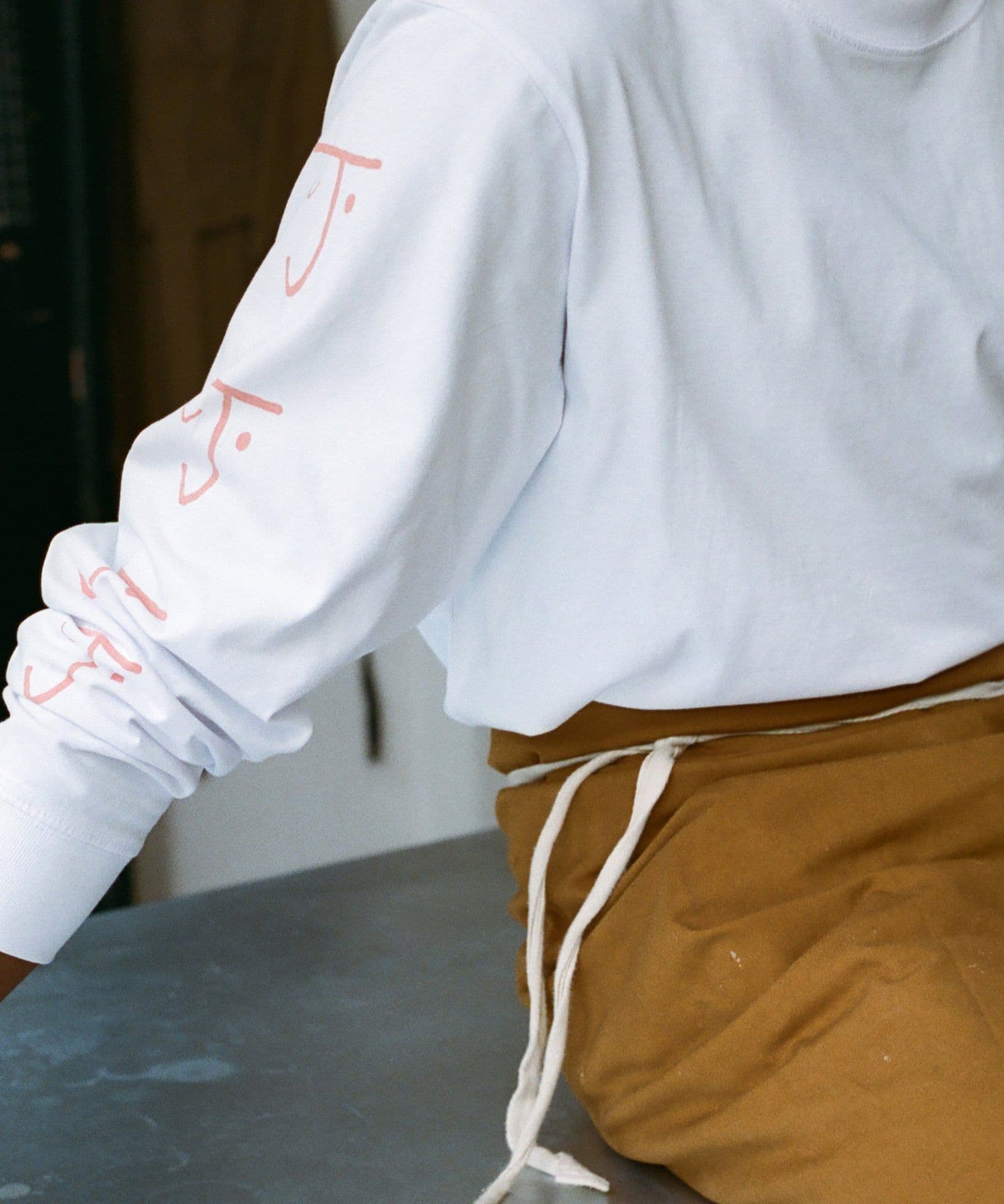 One of the Jolene bakery team wearing the Jolene bakery long sleeve t shirt and house apron