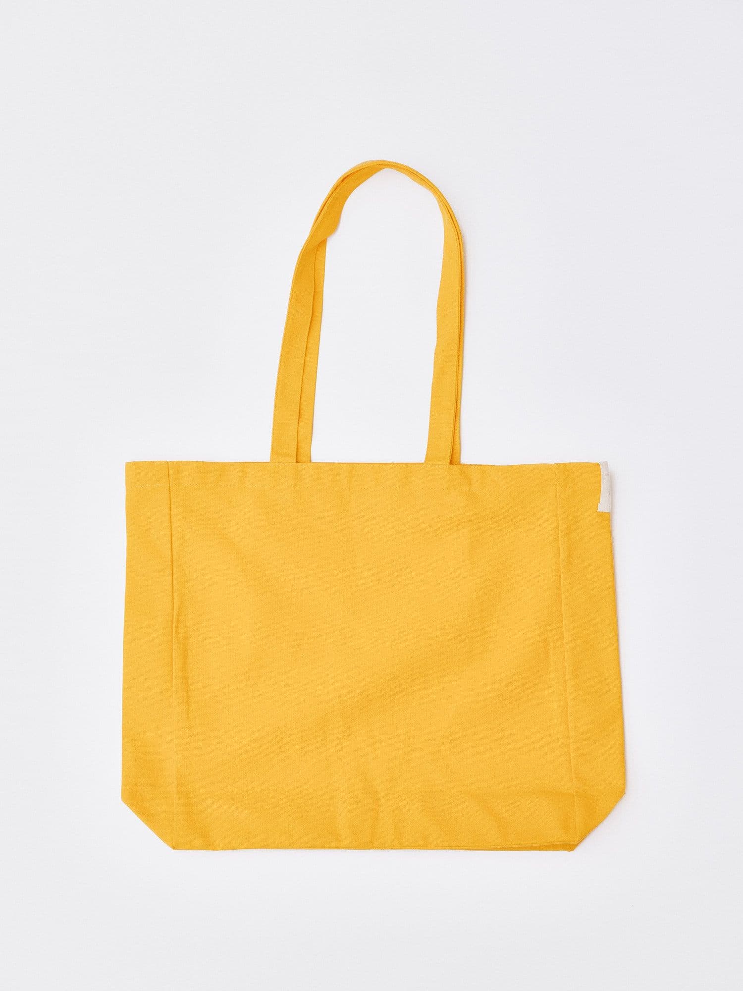 The Jolene Small Tote in yellow pictured on a white background