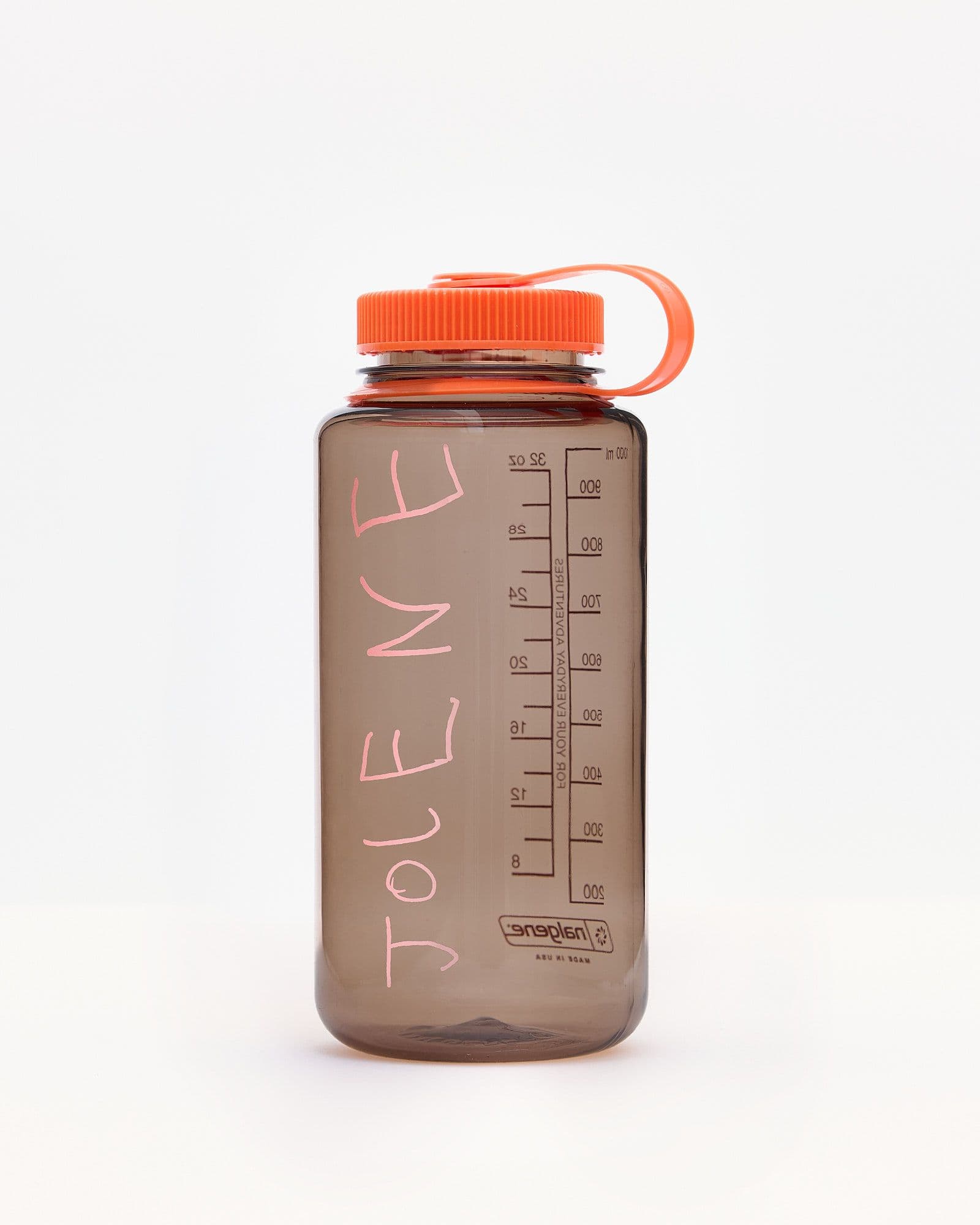 A studio product shot of the Jolene bakery x Nalgene Refill Water Bottle. The bottle is brown with a pink Jolene logo and bright orange top