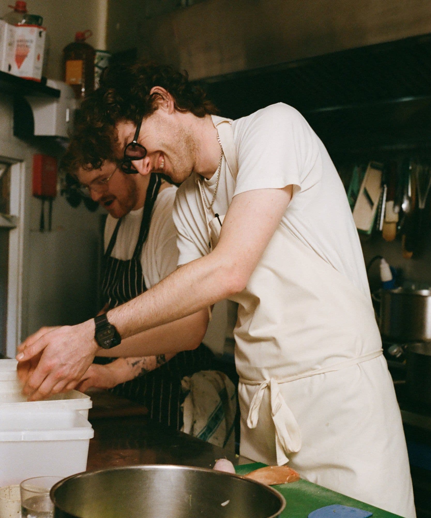 The Jolene Bakery house apron pictured here in the stone colour worn by one of our chefs working in the kitchen