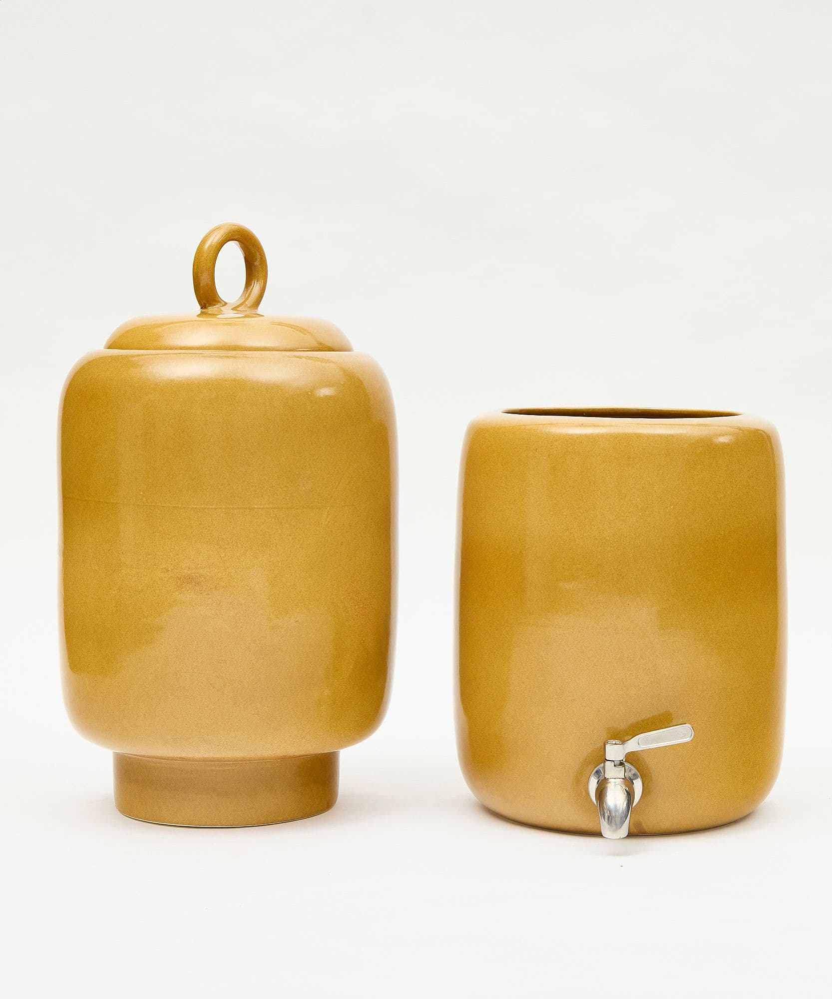 The Jolene bakery x Endless Rhythm water ceramic water filter in limited honey colour on a wooden stand