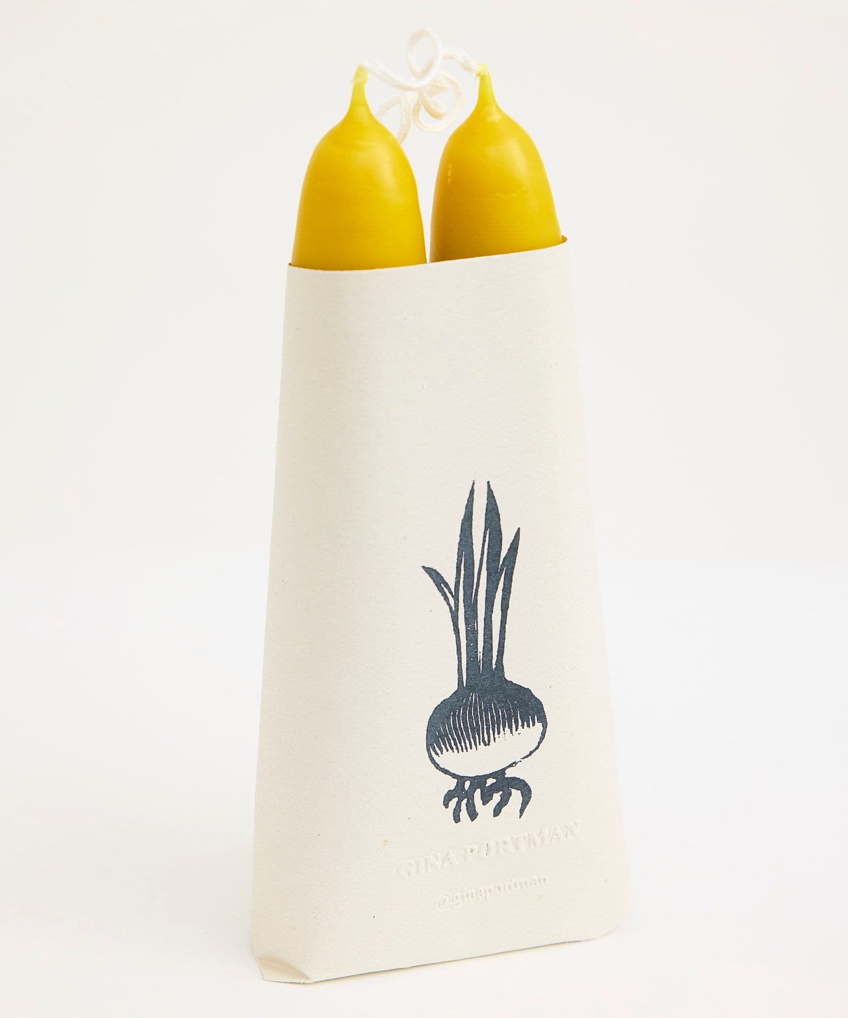 The Jolene bakery x Gina Portman candles wrapped in paper