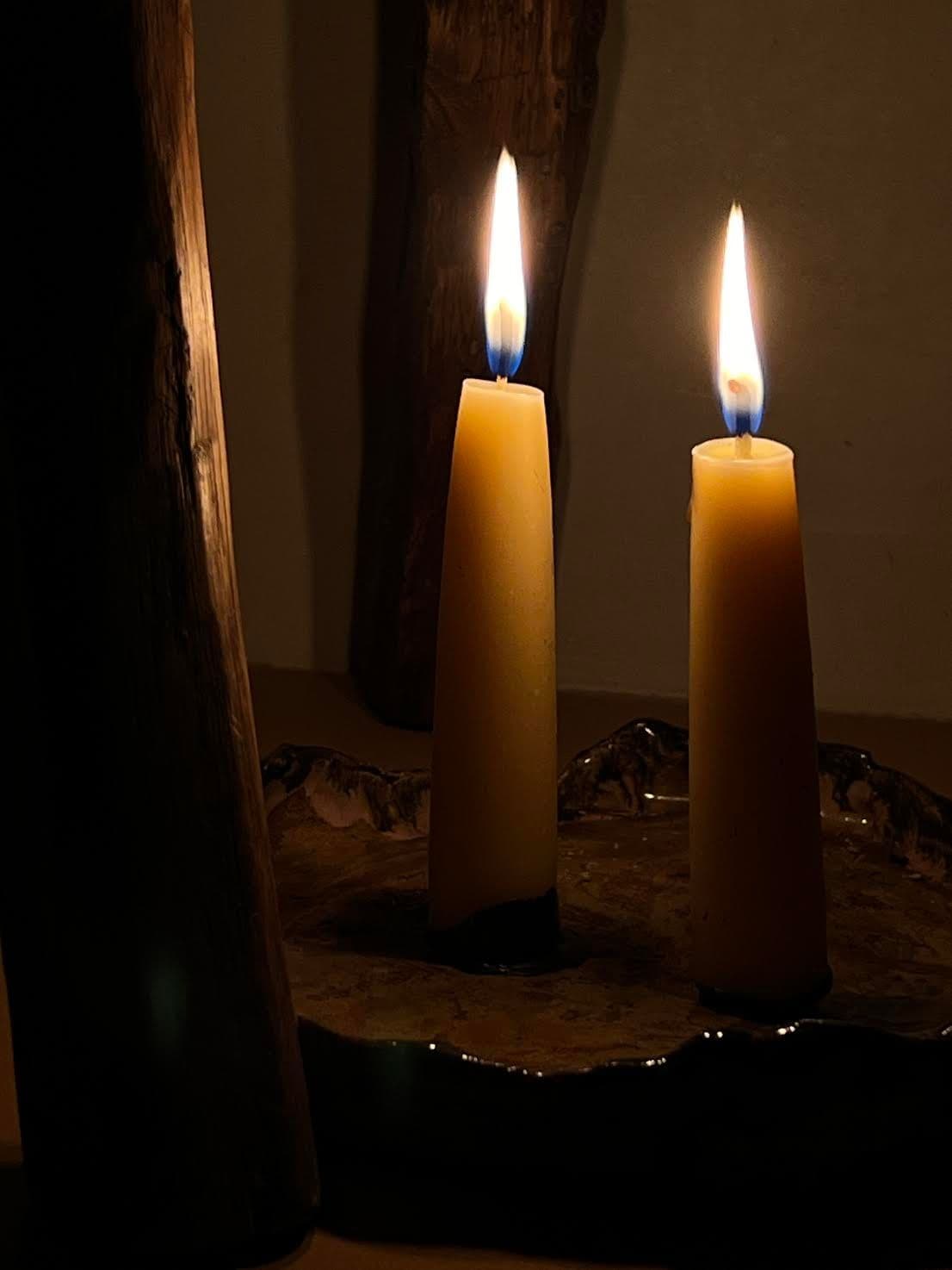 The Jolene bakery x Gina Portman candles lit at night