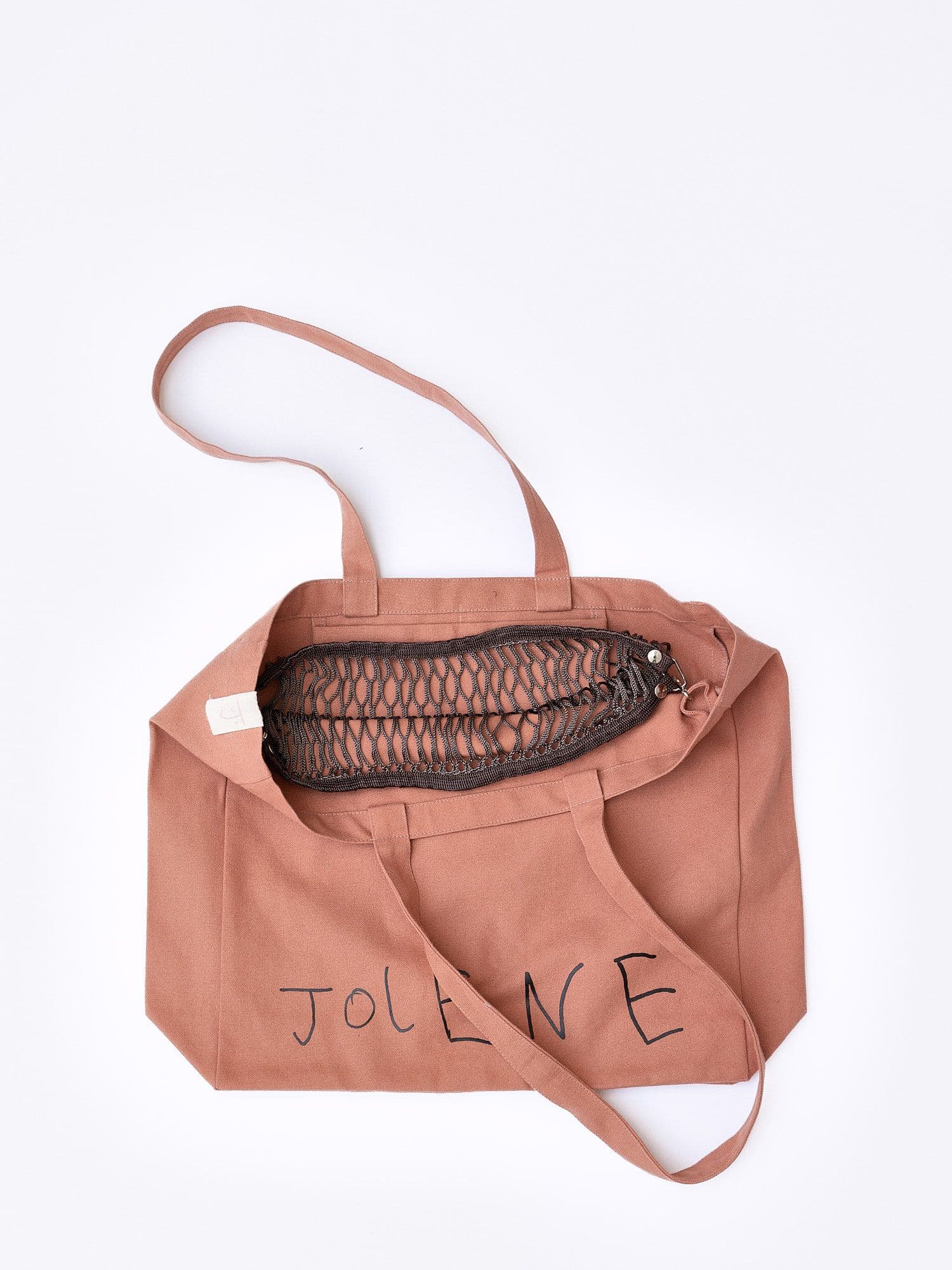 The Jolene bakery x filt of france net poacher pocket in brown, pictured clipped on the inside of the Jolene pink big bag