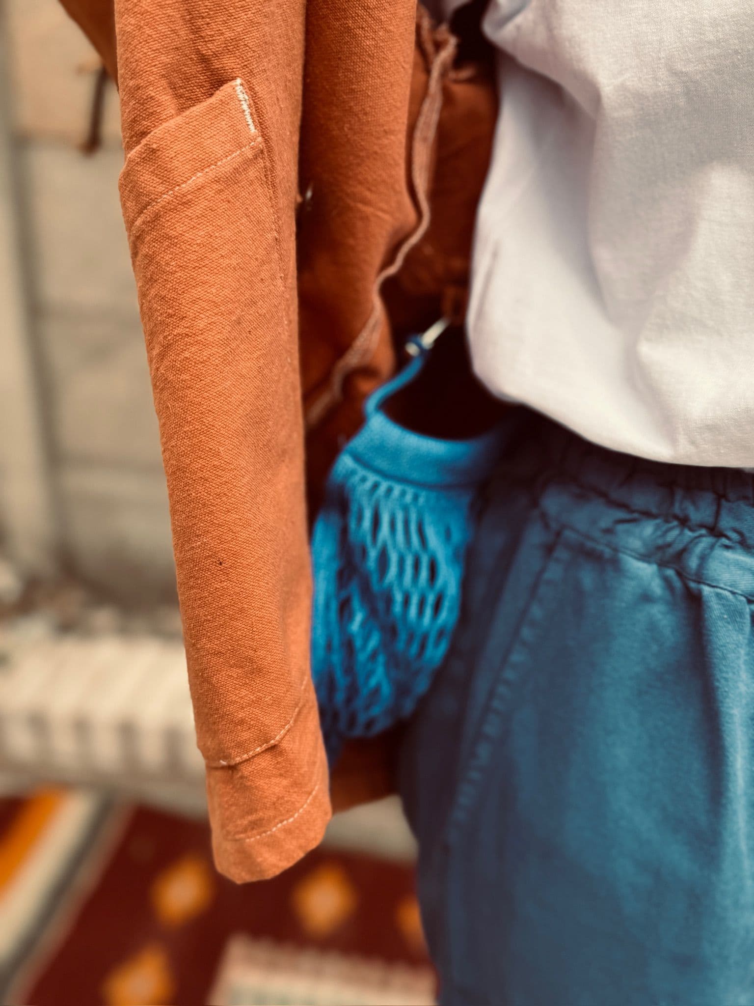 The inside detail of the Jolene pink workwear jacket showing the blue net pocket which is clipped onto the inside